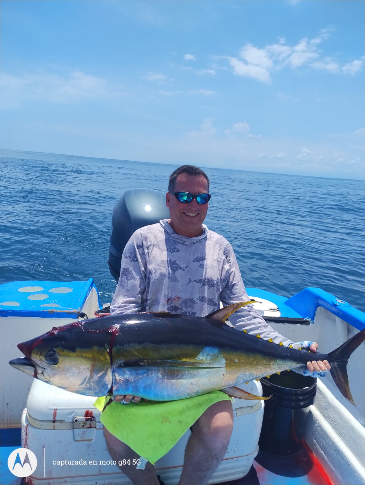 Angler holding a large tuna aboard Soleil